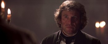 Movie still from “The Patriot” (2000), directed by Roland Emmerich – A person wearing a suit and tie; Close Up shot, Over the shoulder angle