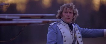 Movie still from “The Patriot” (2000), directed by Roland Emmerich – A man in a blue and white jacket and a black tie; Close Up shot, Over the shoulder angle