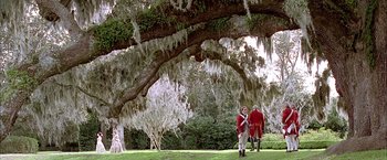 Movie still from “The Patriot” (2000), directed by Roland Emmerich – Two men in period clothing standing under a large tree; Extreme Wide shot, Low angle