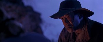 Movie still from “The Patriot” (2000), directed by Roland Emmerich – An older man wearing a black hat and looking at the camera; Close Up shot, Low angle