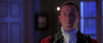 Movie still from “The Patriot” (2000), directed by Roland Emmerich – A person wearing a suit and tie; Close Up shot, Low angle