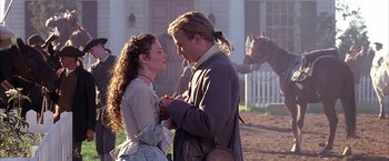 Movie still from “The Patriot” (2000), directed by Roland Emmerich – A man and a woman standing next to each other outside; Medium shot, Over the shoulder angle