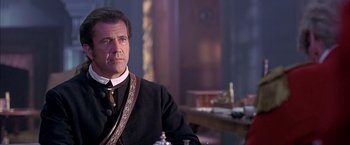 Movie still from “The Patriot” (2000), directed by Roland Emmerich – A person wearing a suit and tie; Close Up shot, Over the shoulder angle