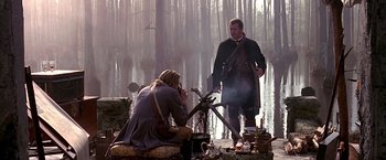 Movie still from “The Patriot” (2000), directed by Roland Emmerich – A man in a black coat and a man in a black coat and a man in a black coat and a man in a black coat and a; Wide shot, Over the shoulder angle
