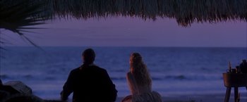 Movie still from “The Patriot” (2000), directed by Roland Emmerich – A man and a woman sitting on a beach at night; Wide shot, Over the shoulder angle