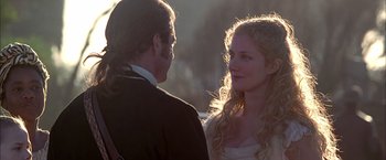 Movie still from “The Patriot” (2000), directed by Roland Emmerich – A man and a woman standing next to each other in front of trees; Close Up shot, Over the shoulder angle