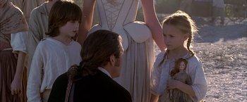 Movie still from “The Patriot” (2000), directed by Roland Emmerich – A man and two girls standing next to each other in front of a woman; Close Up shot, Over the shoulder angle