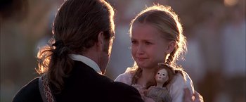 Movie still from “The Patriot” (2000), directed by Roland Emmerich – A man and a girl holding a small doll; Close Up shot, Over the shoulder angle