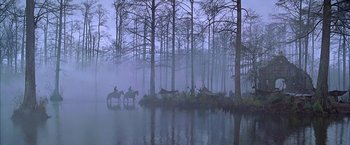 Movie still from “The Patriot” (2000), directed by Roland Emmerich – A group of people riding horses through the water; Extreme Wide shot, High angle