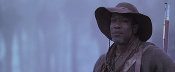 Movie still from “The Patriot” (2000), directed by Roland Emmerich – A man wearing a cowboy hat and a scarf; Close Up shot, Low angle