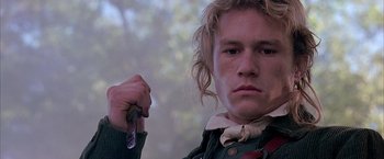 Movie still from “The Patriot” (2000), directed by Roland Emmerich – A young man holding a cell phone in his hand; Close Up shot, Low angle