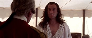Movie still from “The Patriot” (2000), directed by Roland Emmerich – A man with long hair is looking into a mirror; Close Up shot, Over the shoulder angle