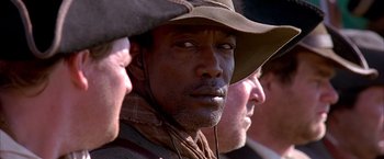 Movie still from “The Patriot” (2000), directed by Roland Emmerich – A person wearing a cowboy hat; Close Up shot, Over the shoulder angle