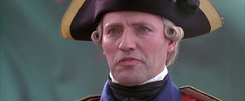 Movie still from “The Patriot” (2000), directed by Roland Emmerich – A person wearing a uniform and a hat; Close Up shot, Low angle
