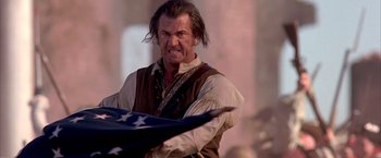 Movie still from “The Patriot” (2000), directed by Roland Emmerich – A person holding an american flag; Close Up shot, Low angle