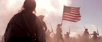 Movie still from “The Patriot” (2000), directed by Roland Emmerich – A group of people holding american flags in a field; Medium shot, Low angle