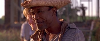Movie still from “The Patriot” (2000), directed by Roland Emmerich – A person wearing a straw hat; Close Up shot, Over the shoulder angle