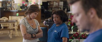 Movie still from “Breaking News in Yuba County” (2021), directed by Tate Taylor – Two women standing next to each other in a room; Medium shot, Over the shoulder angle