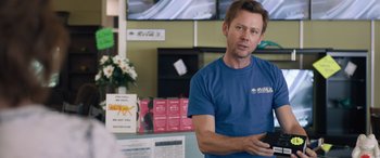 Movie still from “Breaking News in Yuba County” (2021), directed by Tate Taylor – A man holding a cell phone in his hands; Medium shot, Over the shoulder angle