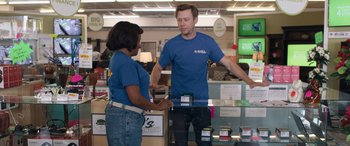 Movie still from “Breaking News in Yuba County” (2021), directed by Tate Taylor – A man and a woman talking to each other in a store; Wide shot, Over the shoulder angle
