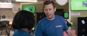 Movie still from “Breaking News in Yuba County” (2021), directed by Tate Taylor – A man in a blue shirt talking to another man; Close Up shot, Over the shoulder angle