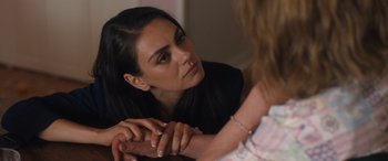 Movie still from “Breaking News in Yuba County” (2021), directed by Tate Taylor – A woman sitting down holding her hands with another woman; Close Up shot, Over the shoulder angle