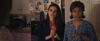 Movie still from “Breaking News in Yuba County” (2021), directed by Tate Taylor – A woman with her hands clasped in front of her face; Close Up shot, Over the shoulder angle