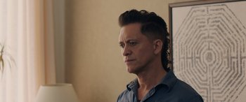 Movie still from “Breaking News in Yuba County” (2021), directed by Tate Taylor – A man with long hair is looking into the distance; Close Up shot, Over the shoulder angle