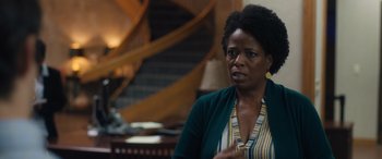 Movie still from “Breaking News in Yuba County” (2021), directed by Tate Taylor – An older black woman is sitting in front of a staircase; Close Up shot, Over the shoulder angle