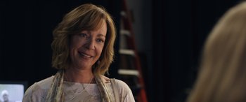 Movie still from “Breaking News in Yuba County” (2021), directed by Tate Taylor – A person smiling for the camera; Close Up shot, Over the shoulder angle