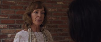 Movie still from “Breaking News in Yuba County” (2021), directed by Tate Taylor – An older woman standing in front of a brick wall; Close Up shot, Over the shoulder angle