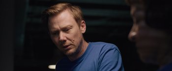 Movie still from “Breaking News in Yuba County” (2021), directed by Tate Taylor – A person wearing a blue t - shirt; Close Up shot, Over the shoulder angle