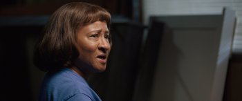 Movie still from “Breaking News in Yuba County” (2021), directed by Tate Taylor – An older woman wearing a blue shirt looking to her left; Close Up shot, Low angle