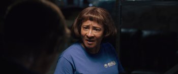 Movie still from “Breaking News in Yuba County” (2021), directed by Tate Taylor – A person wearing a blue t - shirt; Close Up shot, Over the shoulder angle