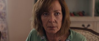 Movie still from “Breaking News in Yuba County” (2021), directed by Tate Taylor – An older woman is looking directly at the camera; Close Up shot, Over the shoulder angle