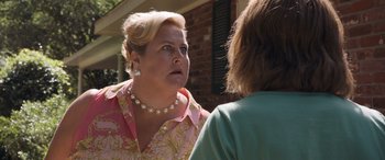 Movie still from “Breaking News in Yuba County” (2021), directed by Tate Taylor – A woman in a pink shirt talking to another woman; Close Up shot, Over the shoulder angle