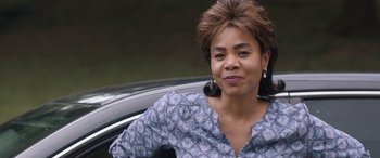 Movie still from “Breaking News in Yuba County” (2021), directed by Tate Taylor – A woman sitting in the passenger seat of a car; Close Up shot, Over the shoulder angle