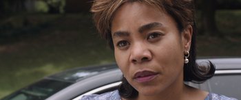 A woman's face in front of a car