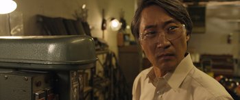 Movie still from “Breaking News in Yuba County” (2021), directed by Tate Taylor – An older man wearing glasses and a white button up shirt; Close Up shot, Low angle