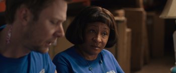 Movie still from “Breaking News in Yuba County” (2021), directed by Tate Taylor – A woman in a blue shirt is looking at a man; Close Up shot, Over the shoulder angle