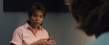 Movie still from “Breaking News in Yuba County” (2021), directed by Tate Taylor – A woman in a pink shirt talking to someone in a mirror; Close Up shot, Over the shoulder angle