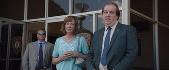 Movie still from “Breaking News in Yuba County” (2021), directed by Tate Taylor – A man and a woman standing next to each other; Medium shot, Low angle