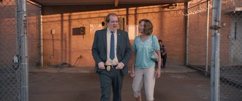 Movie still from “Breaking News in Yuba County” (2021), directed by Tate Taylor – A man and a woman walking down a street; Medium shot, Over the shoulder angle