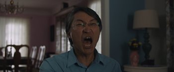 Movie still from “Breaking News in Yuba County” (2021), directed by Tate Taylor – An older man with glasses is yelling with his mouth open; Close Up shot, Low angle