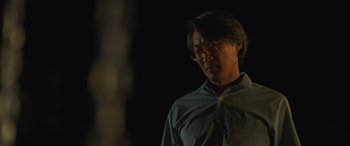 Movie still from “Breaking News in Yuba County” (2021), directed by Tate Taylor – A man with glasses is standing in the dark; Close Up shot, Low angle