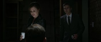 Movie still from “Broken” (2021), directed by Patrick Phillips – A woman and a man in a suit and tie; Medium shot, Over the shoulder angle