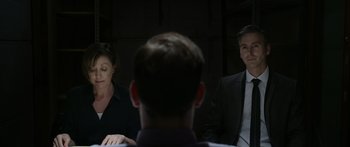 Movie still from “Broken” (2021), directed by Patrick Phillips – A man and a woman sitting in front of another man; Medium shot, Over the shoulder angle