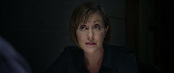 Movie still from “Broken” (2021), directed by Patrick Phillips – A person with short brown hair; Close Up shot, Low angle