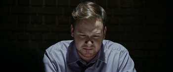 Movie still from “Broken” (2021), directed by Patrick Phillips – A person wearing a dress shirt and tie; Close Up shot, Low angle