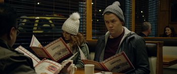 Movie still from “Broken” (2021), directed by Patrick Phillips – A man and a woman sitting at a table reading a menu; Medium shot, Over the shoulder angle